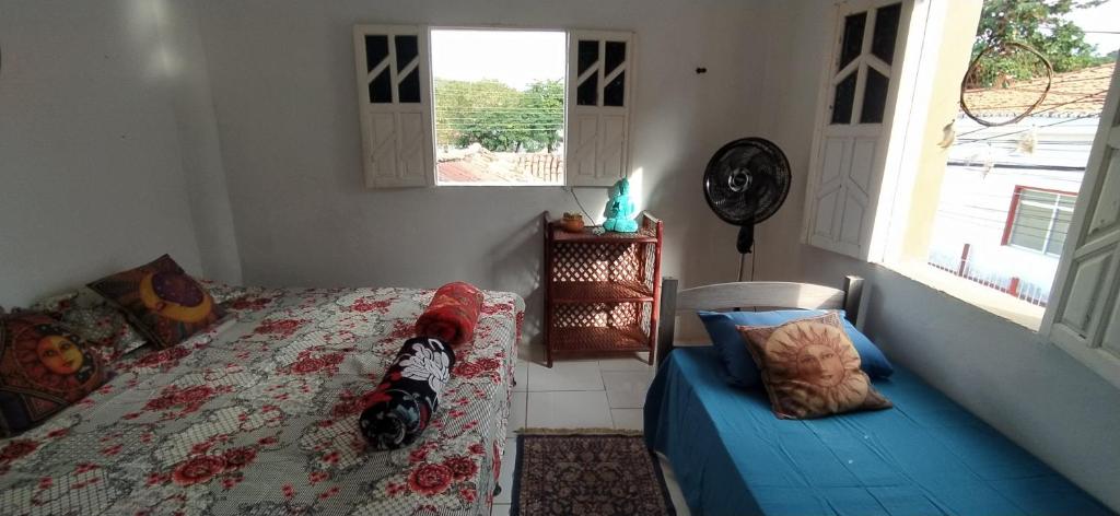 a bedroom with a bed and a cat sitting on it at Hostel do Capao in Palmeiras