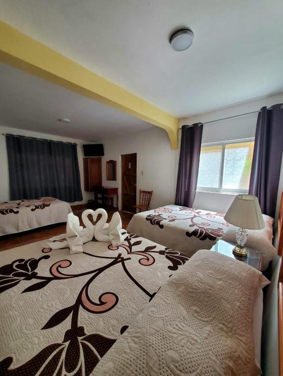 Postel nebo postele na pokoji v ubytování Hotel Posada Camelinas