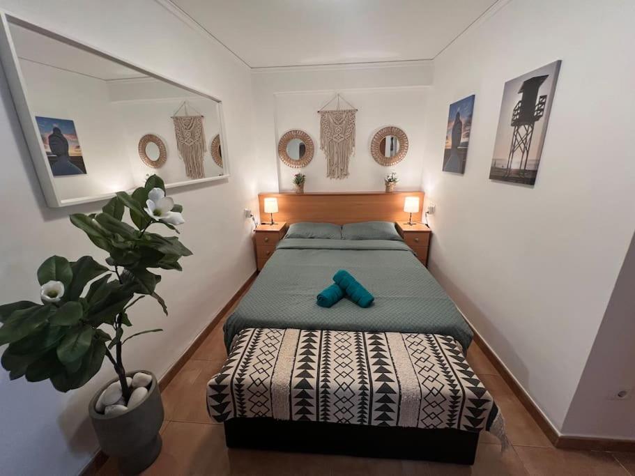 a bedroom with a bed with a blue object on it at Apartamento Monika Playa y Grau in Gandía