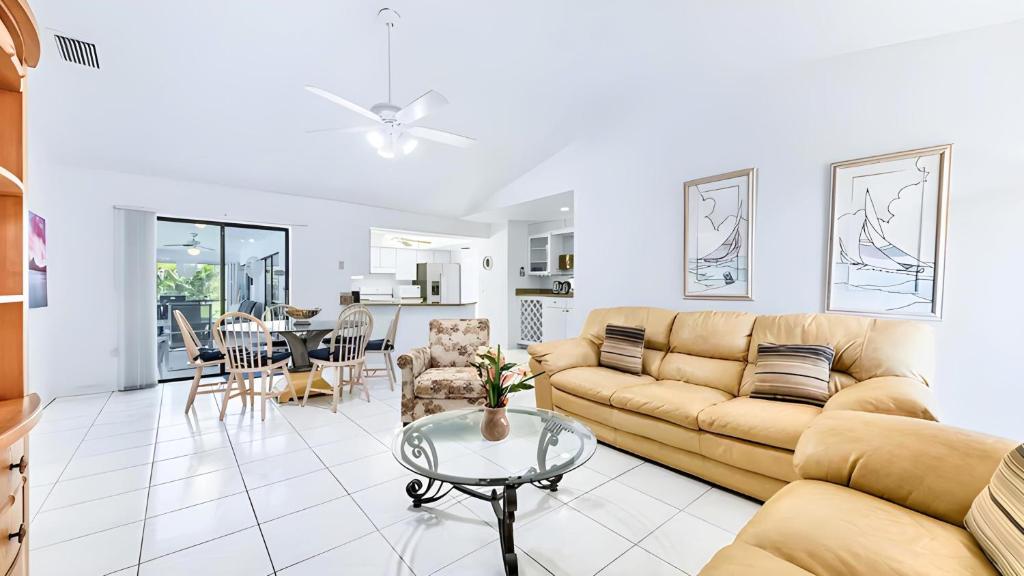 a living room with a couch and a table at New house 3-room pool lake view in Port Charlotte
