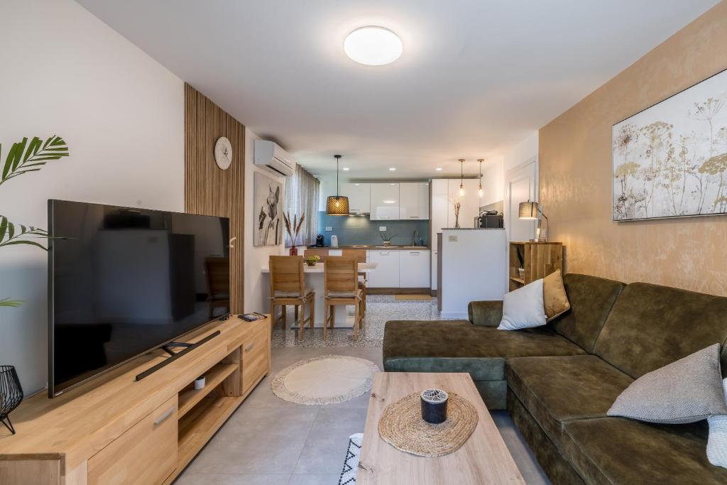 Televízia a/alebo spoločenská miestnosť v ubytovaní Olive Shade - Apartment near the Beach