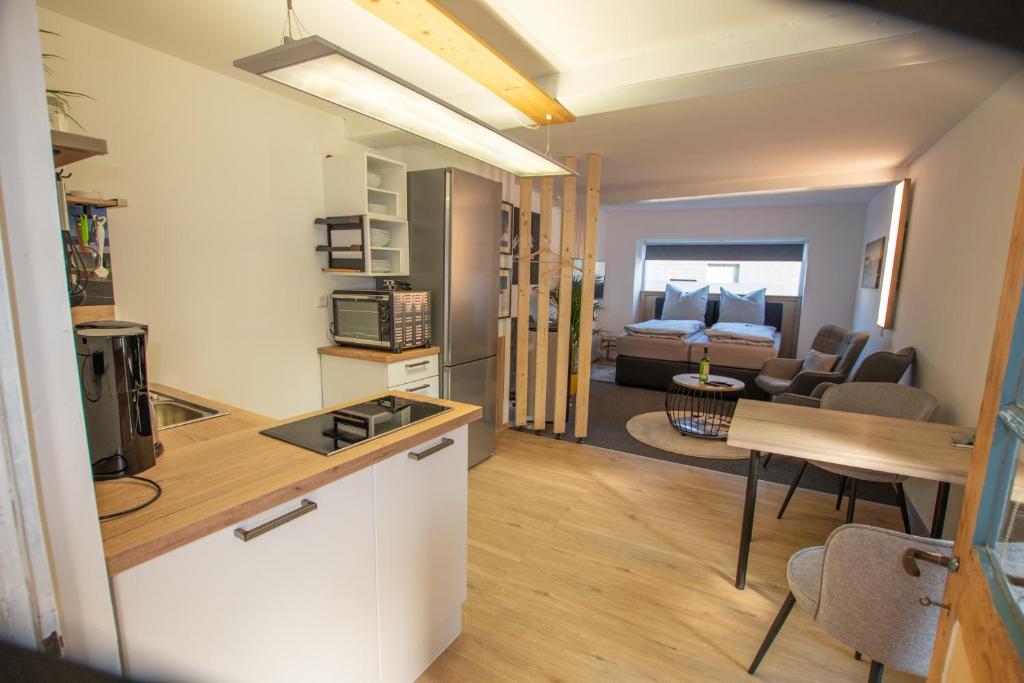 a kitchen and a living room with a table at Westerwald Apartment DRIE600 in Driedorf