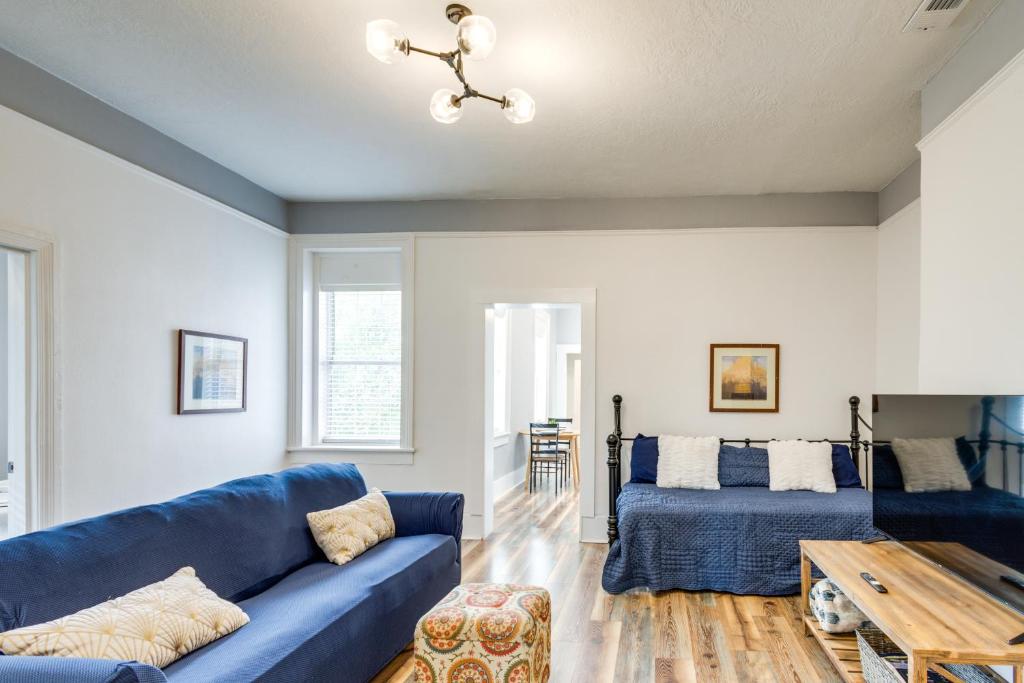 a living room with a blue couch and a table at Modern Augusta Vacation Rental about 1 Mi to Colleges! in Augusta
