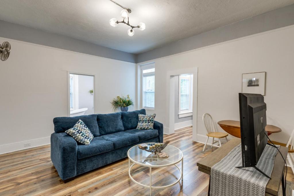 a living room with a blue couch and a tv at Renovated Augusta Apartment about 1 Mi to Downtown! in Augusta