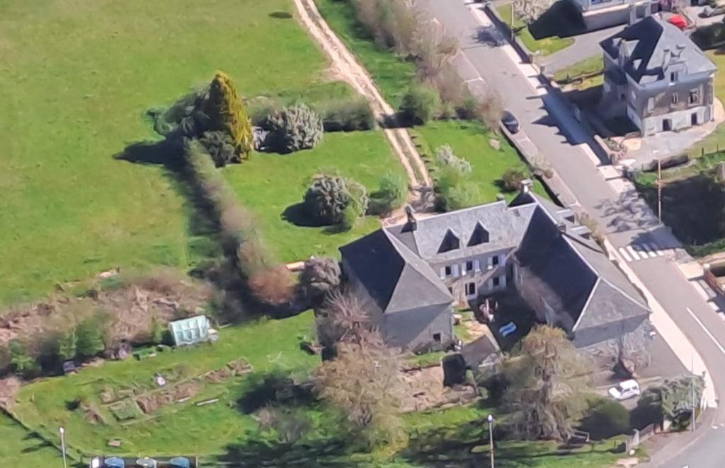 an aerial view of a large house with a yard at LES PIPISTRELLES 19 - chambre d'hotes in Meymac