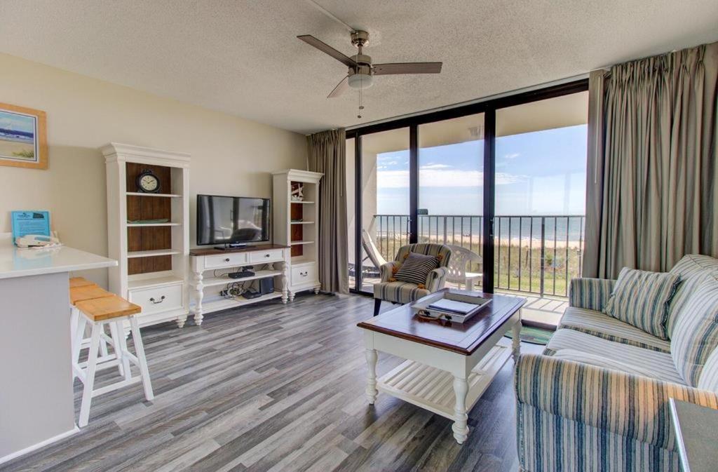a living room with a couch and a table at 0204 Seaside Sanctuary by Atlantic Towers in Carolina Beach
