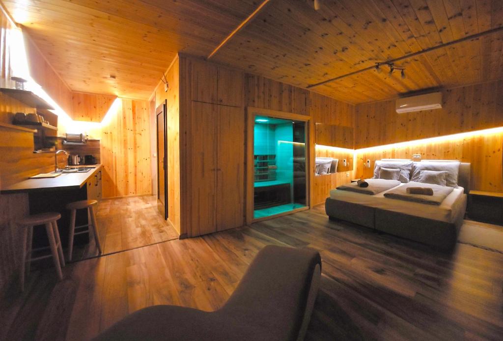 a bedroom with a bed in a wooden room at Mámor Kuckó in Kistolmács