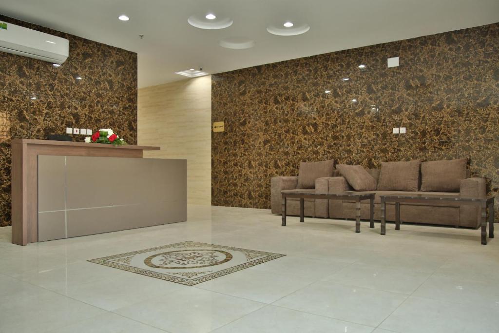 a lobby with couches and a counter in a building at أندلسية الوسام in Taif