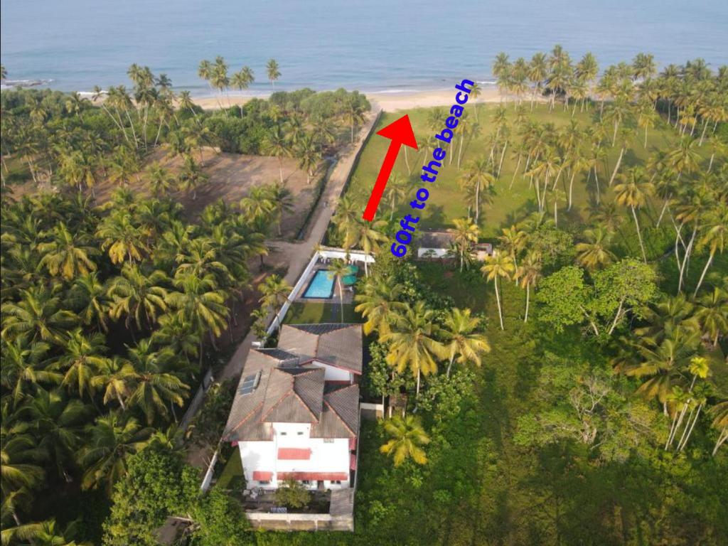 an aerial view of a house with a red arrow at Darshana Beach Hotel in Kosgoda