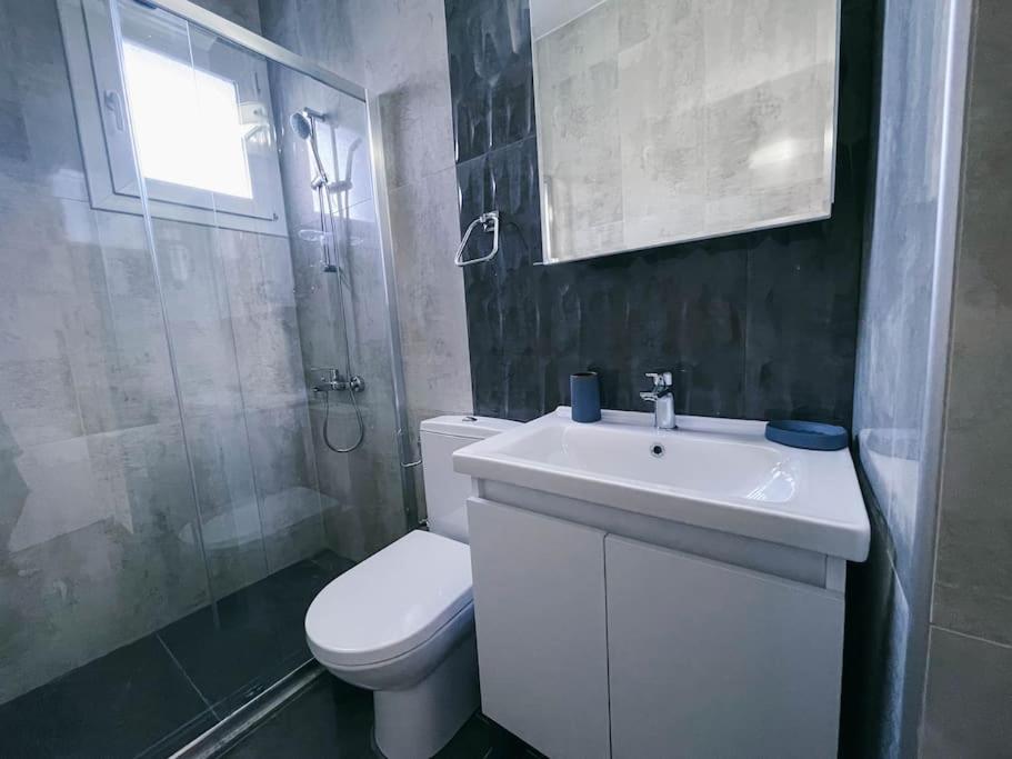 a bathroom with a sink and a toilet and a shower at 1 Bedroom Design Apartment in Iskele North Cyprus in Iskele