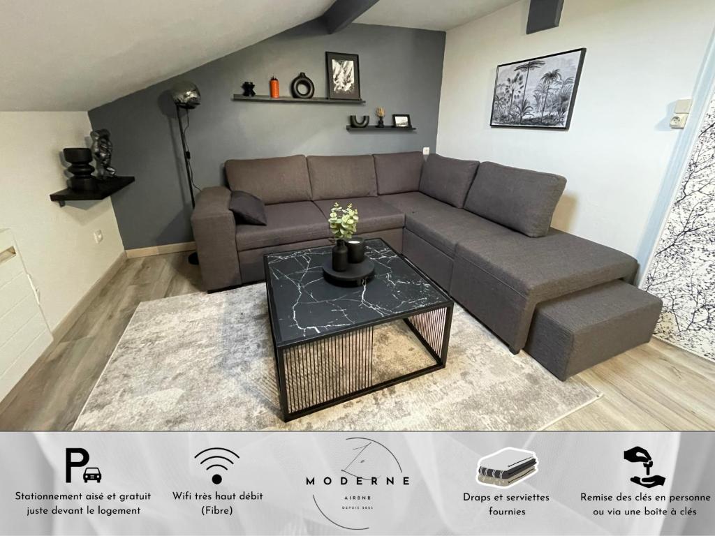 a living room with a couch and a table at Le Moderne in La Chapelle-Saint-Luc