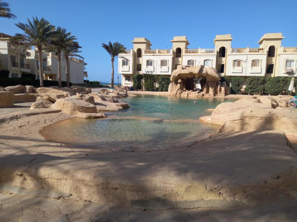 a swimming pool in front of a resort at Chalet in Belagio Ain Sokhna in Ain Sokhna