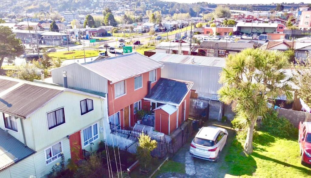 an aerial view of a city with houses and a car at Hospedaje Familiar Doña Juanita in Puerto Montt