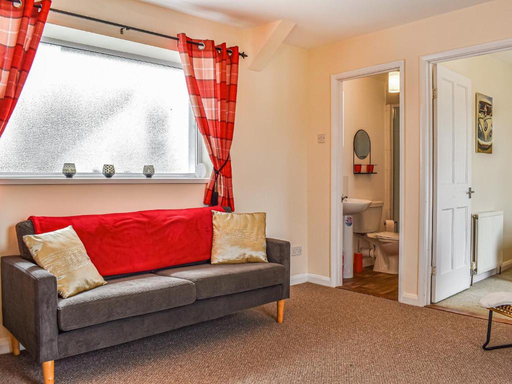 a living room with a couch and a window at Roseus - Uk44706 in Combe Martin