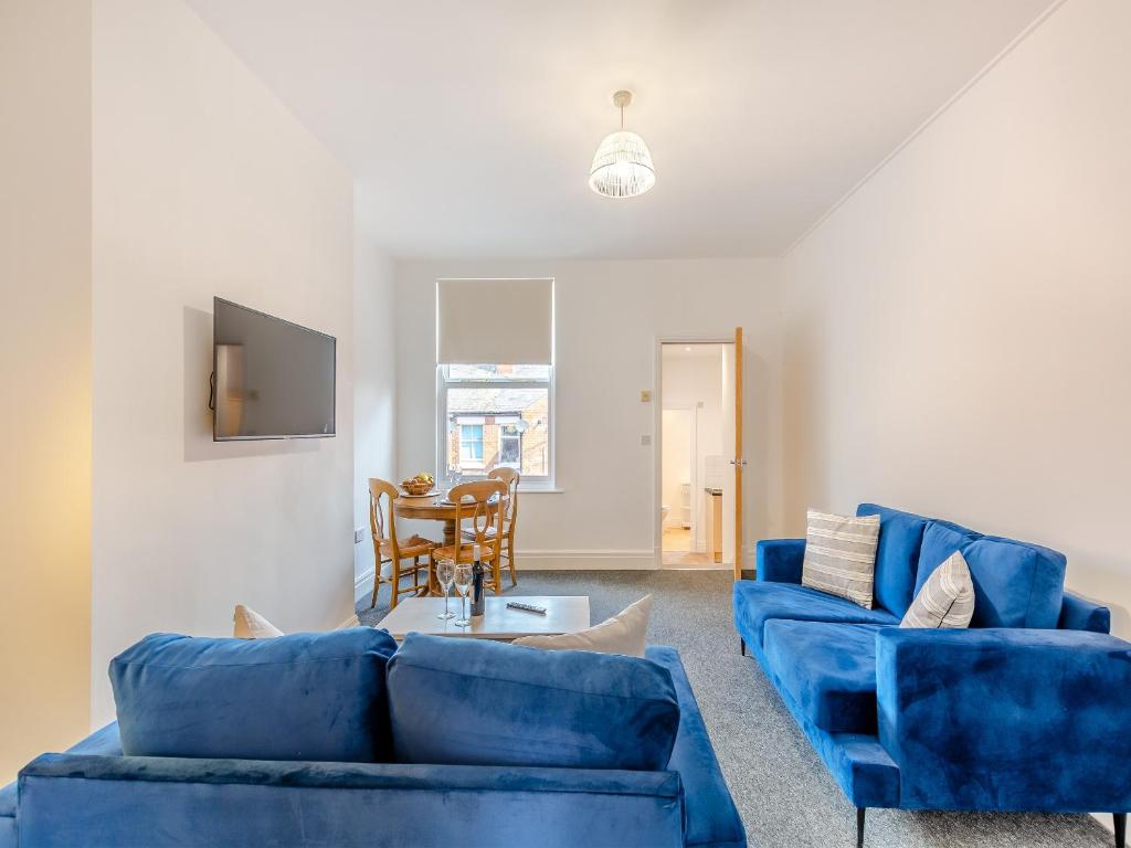 een woonkamer met twee blauwe banken en een tafel bij Clifton House A - Uk42843 in Lytham St Annes