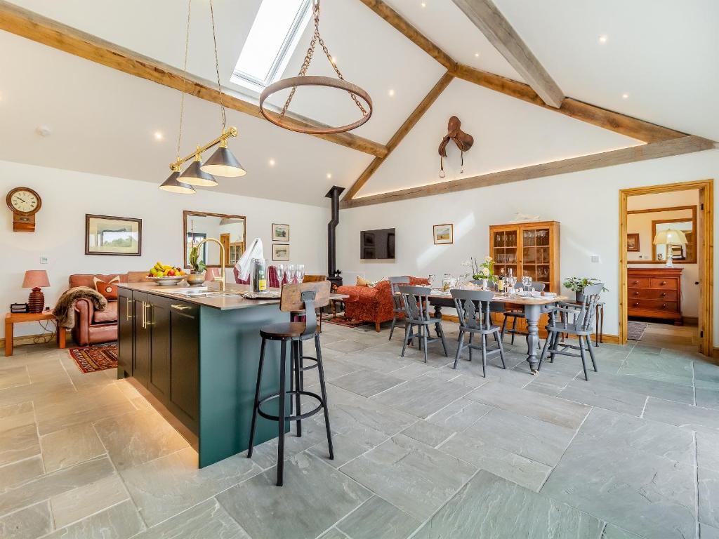a kitchen and living room with a table and chairs at Loch Farm Stables in Watton