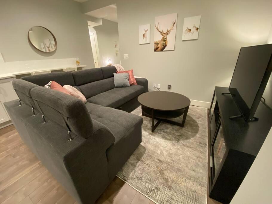 a living room with a couch and a table at Home Suite Home in Promontory Heights 1bdrm suite in Chilliwack