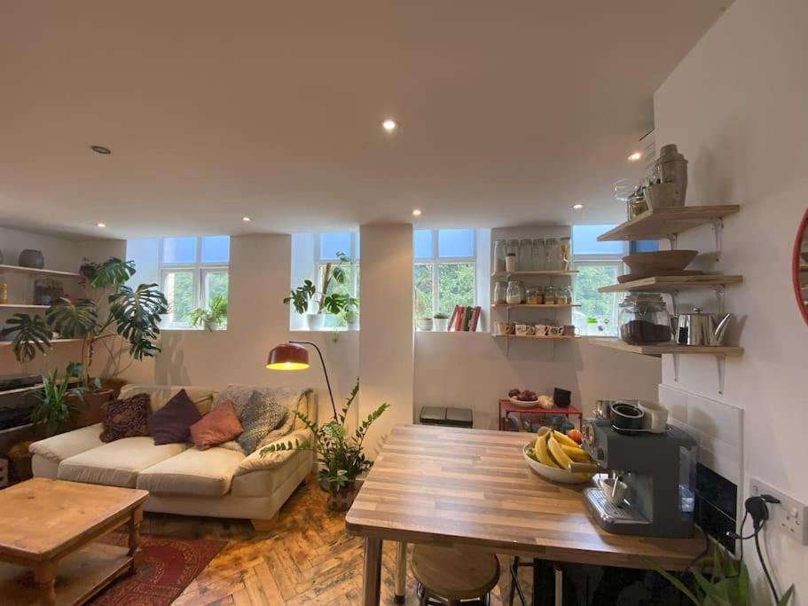 a living room with a couch and a table at Biophilic Duplex - Family & Pet Friendly in Sheffield