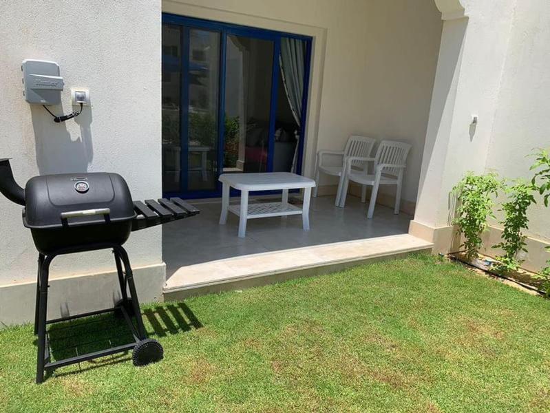 a barbecue grill sitting on the side of a house at Marassi in El Alamein