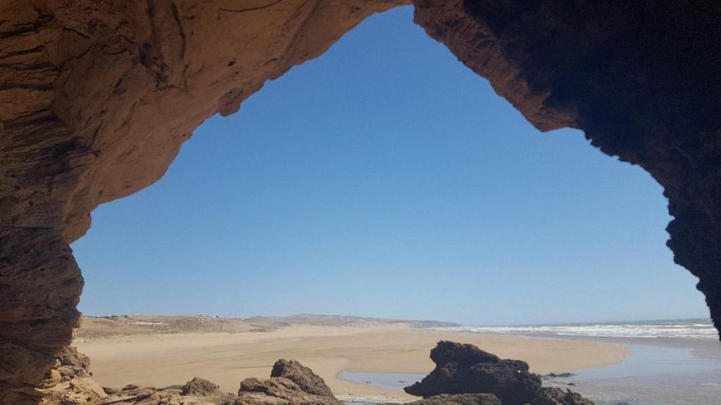 a view of a beach from inside a cave at sidi kaouki ayt karoum in Sidi Kaouki