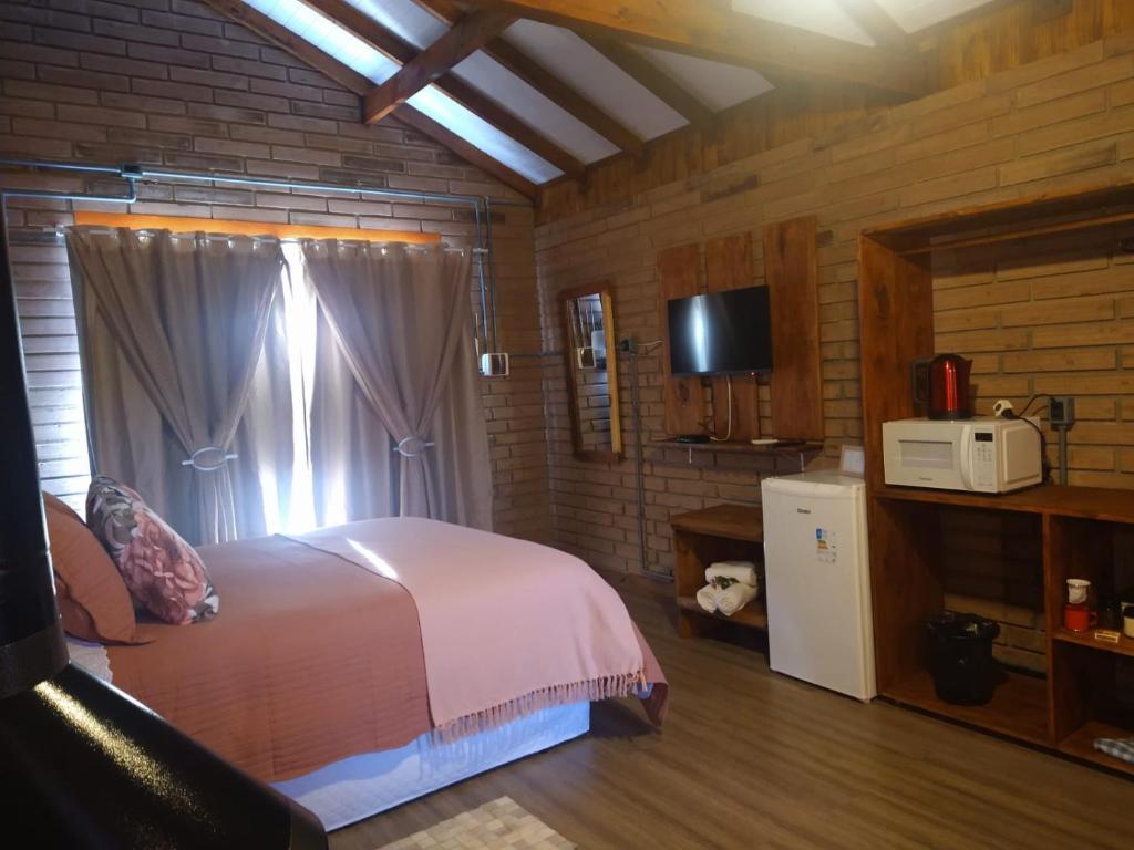 Postel nebo postele na pokoji v ubytování Chalés Corucacas