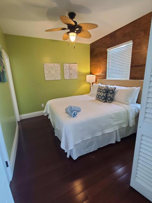a bedroom with a bed and a ceiling fan at Duval Street Suite w kitchen and shared heated pool in Key West