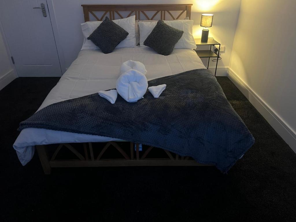 a bedroom with a bed with a stuffed animal on it at Ashfield New Place in Newcastle under Lyme