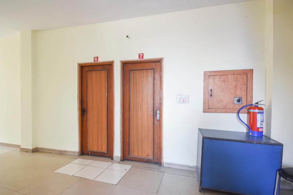 a room with two wooden doors and a counter at Hotel Lazeez in Karnāl