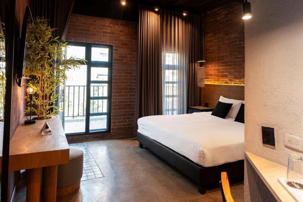 Postel nebo postele na pokoji v ubytování The Art Hotel Medellin
