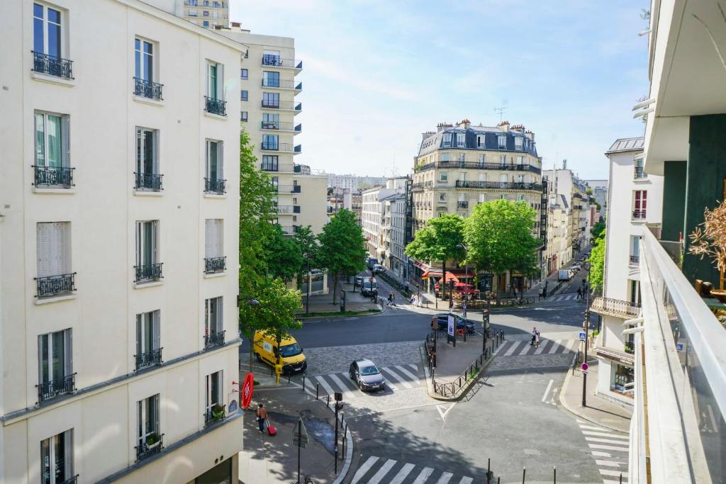 a view of a city street from a building at Cozy 58 m near Butte-aux-Cailles in Paris