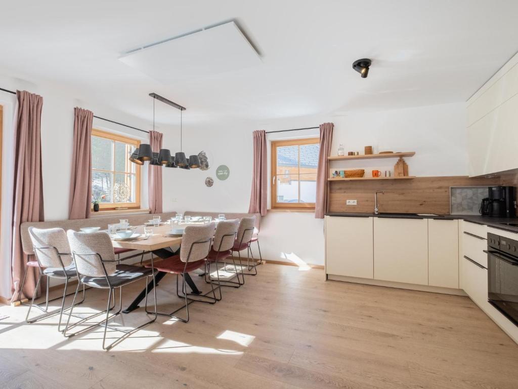 a kitchen and dining room with a table and chairs at Haus Lilyan in Donnersbachwald