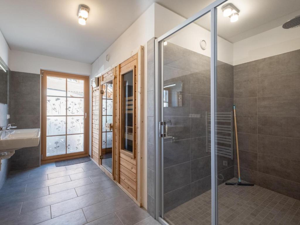 a bathroom with a glass shower and a sink at Haus Lilyan in Donnersbachwald
