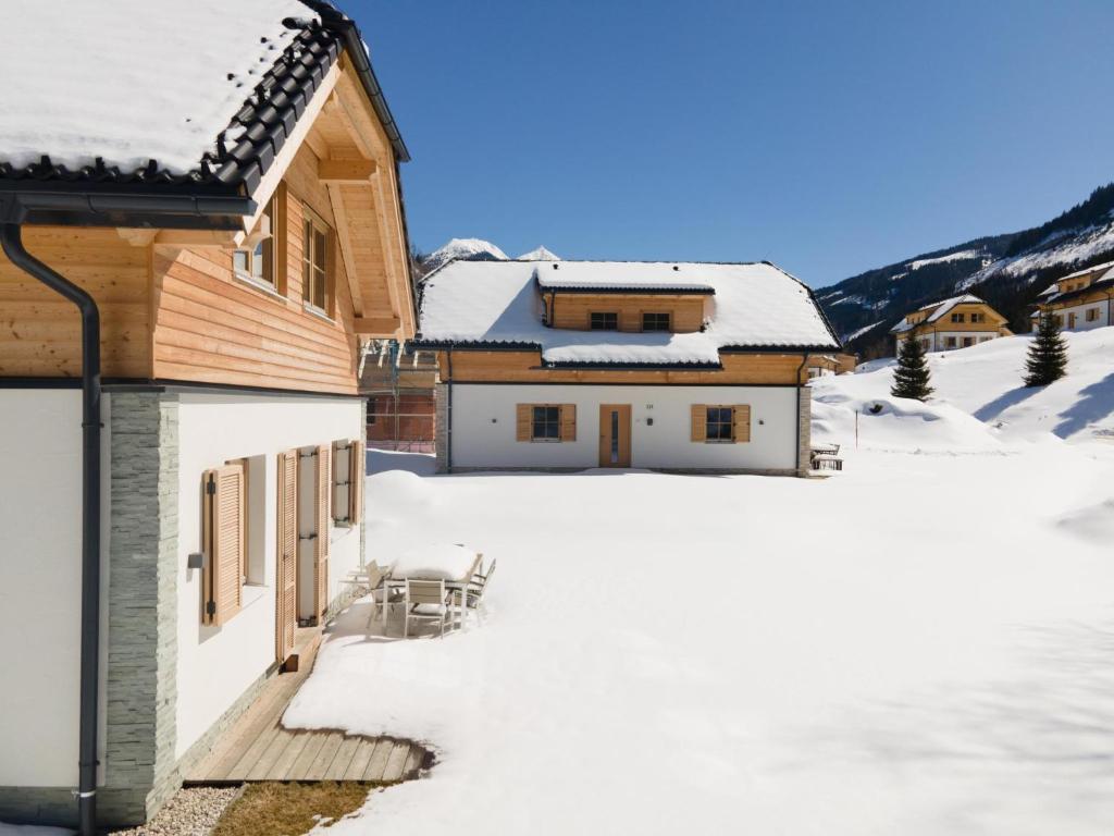 a house with a deck in the snow at Haus Lilyan in Donnersbachwald