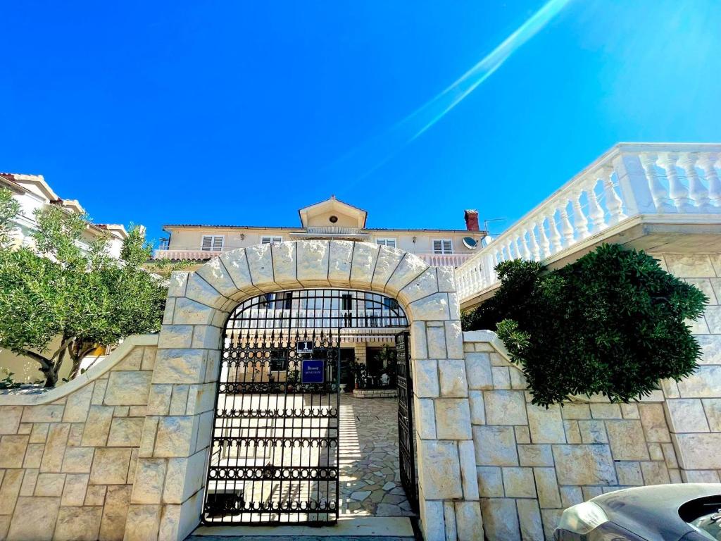 an entrance to a building with an iron gate at Apartments by the sea Jezera, Murter - 5123 in Jezera