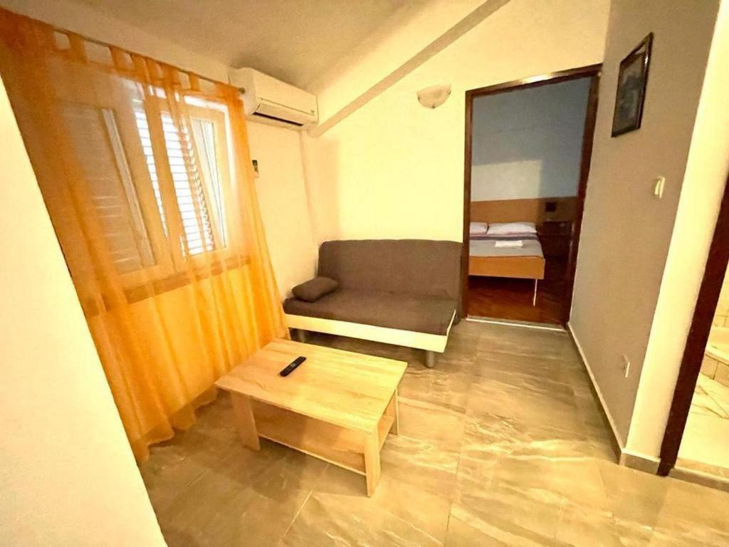 a small living room with a couch and a table at Apartments by the sea Jezera, Murter - 5123 in Jezera