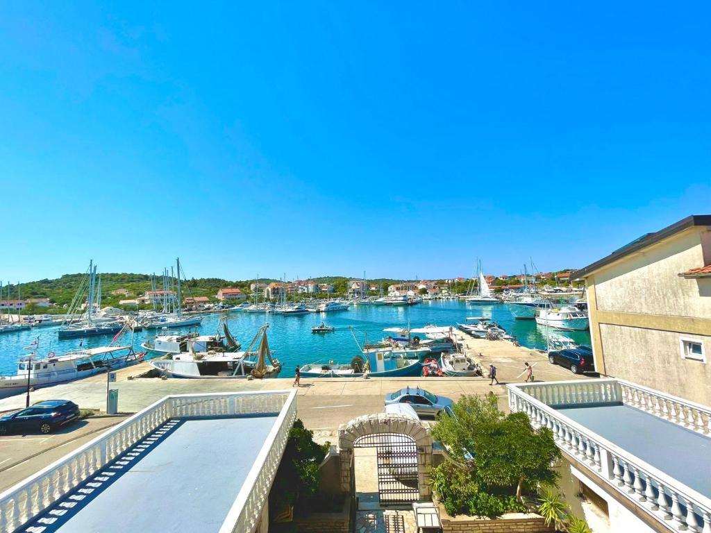 a view of a marina with boats in the water at Apartments by the sea Jezera, Murter - 5123 in Jezera