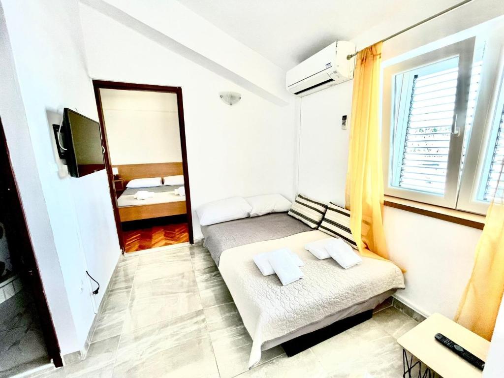a small bedroom with a bed and a mirror at Apartments by the sea Jezera, Murter - 5123 in Jezera