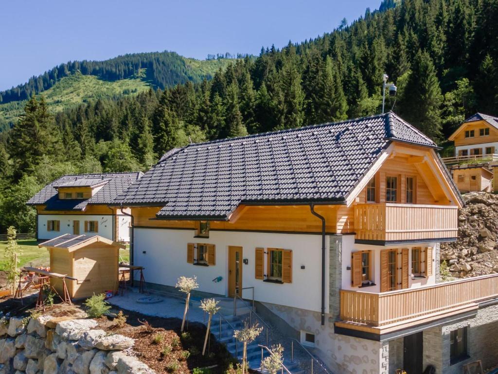 une maison avec un toit dans les montagnes dans l'établissement Apart Heidi, à Donnersbachwald
