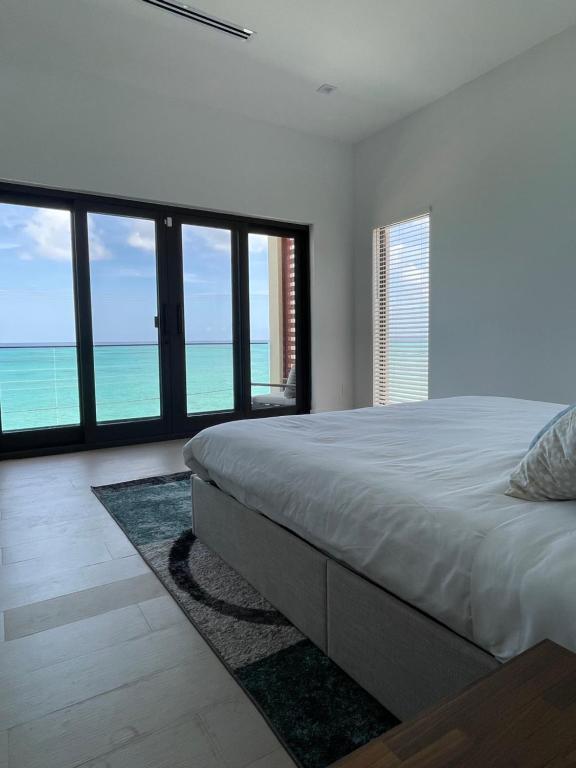 a bedroom with a bed with a view of the ocean at Horizon West in Nassau