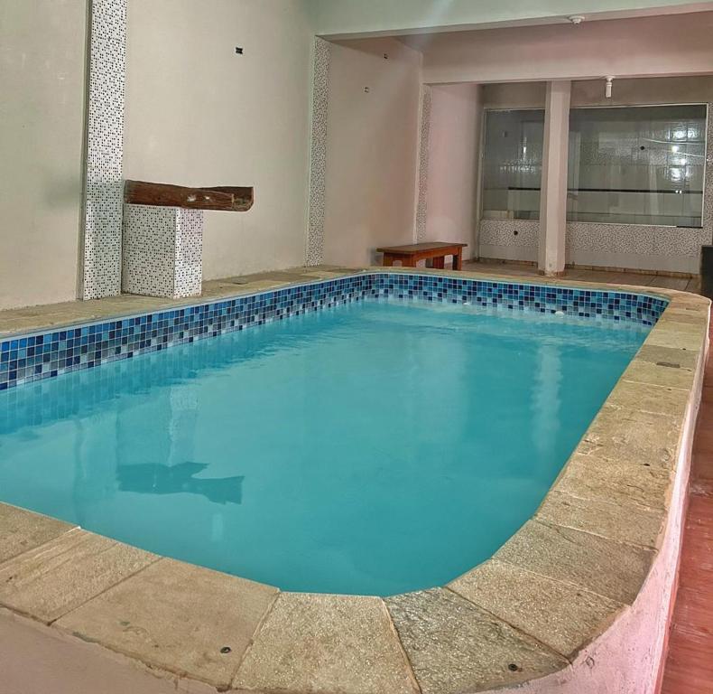 una grande piscina con acqua blu in un edificio di Pousada Chafariz a Pirenópolis
