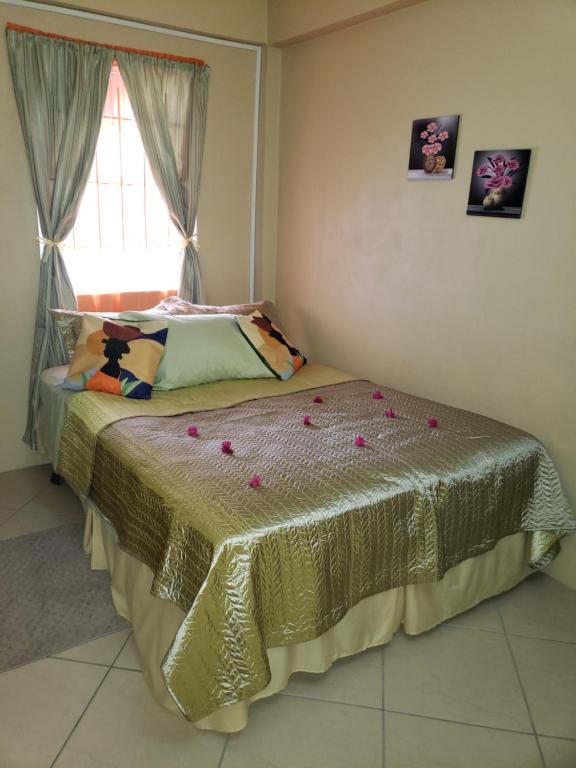 a bedroom with a bed with flowers on it at SK S Haven #1 in Castries