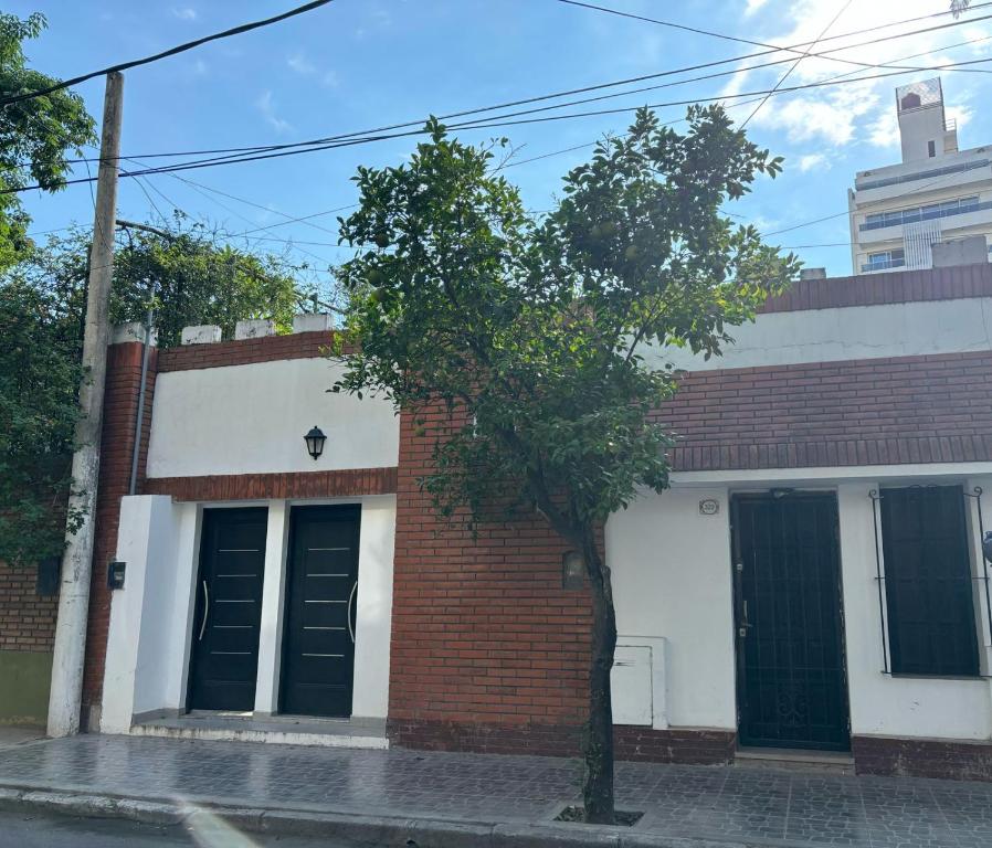 a brick building with a tree in front of it at Casa Blanca in Santiago del Estero