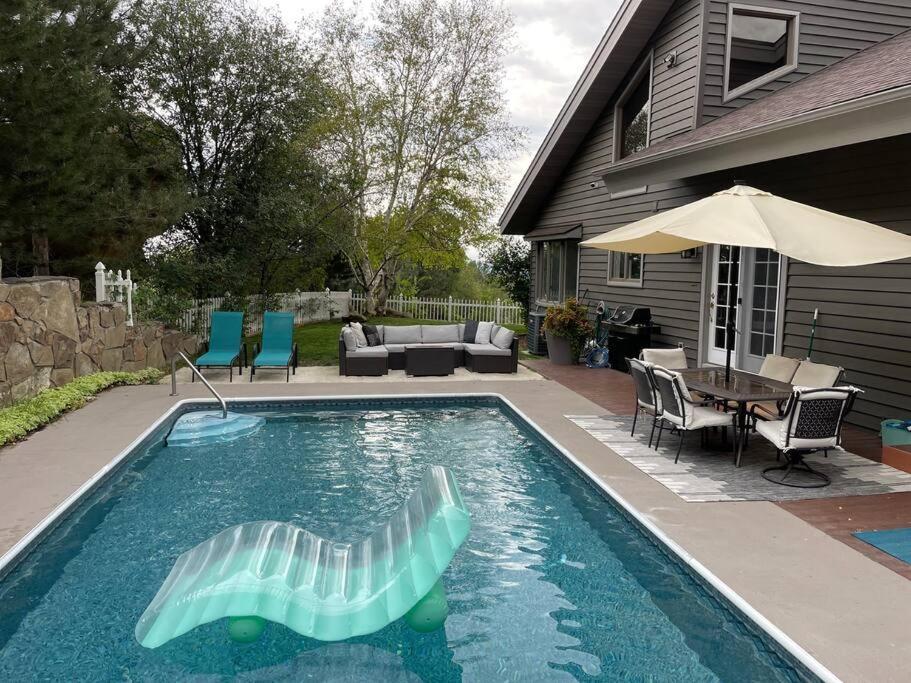 a swimming pool with a raft in a yard at Large Luxury Private 5BDRM Home With Heated Pool in Billings