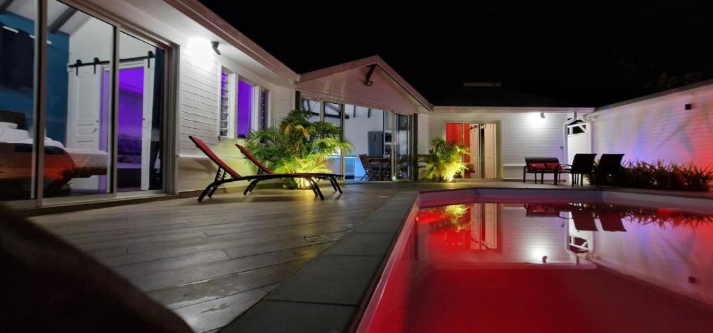 a house with a swimming pool at night at La villa Tina in Ducos