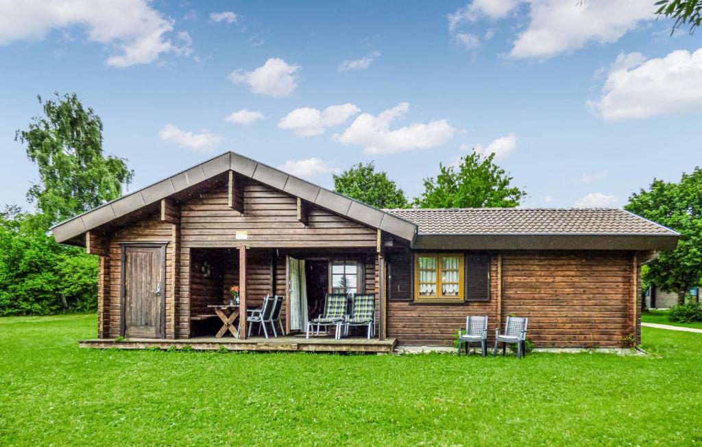 a small log cabin with a green lawn at Ferienhaus Donau 89 in Hayingen