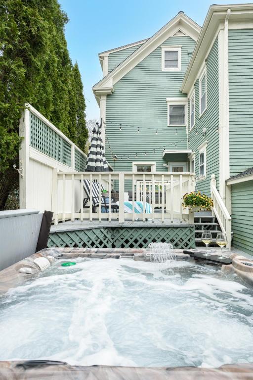 a house with a large pool in front of a house at The Front Porch Vacation Rentals in Bristol