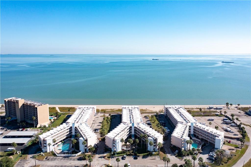 an aerial view of a resort near the ocean at Waterfront North Beach Condo with beach and pool access in Corpus Christi