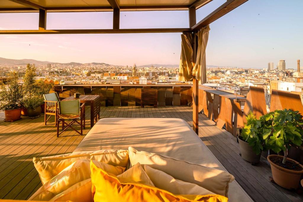 a balcony with a bed and a view of a city at Apartment with Terrace Views of BCN in Barcelona