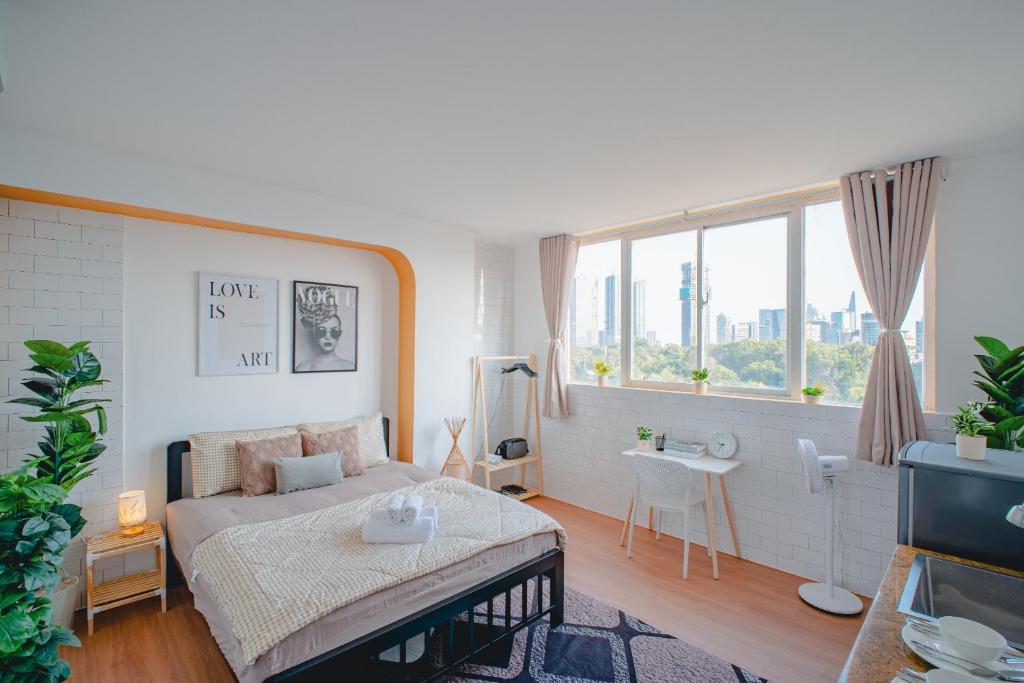 a bedroom with a bed and a large window at La Casa Di Decembre Sai Gon in Ho Chi Minh City
