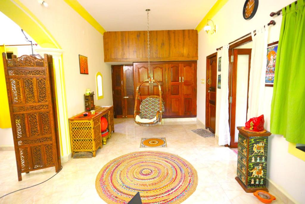 a living room with a large rug on the floor at Shivalaya Arunachala in Tiruvannāmalai